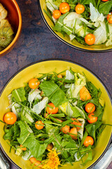 Salad from herbs and physalis.