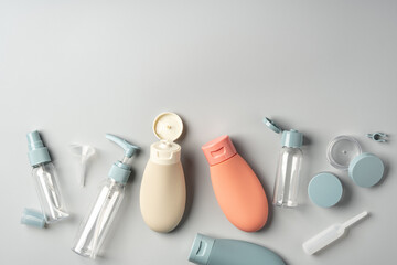Variety of travel-sized containers displayed against a bright blue background