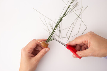 step in creative process, DIY, autumn craft, handmade bird crafted from pine cones and twigs, the...