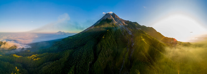 Beautiful Panoramic drone shot of Merapi volcano from above Hulu Sungai Opak in the morning 