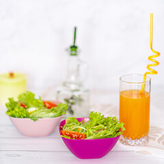 bowls of snacks and cookies on wooden white table. Rice, salads, juice, crackers.