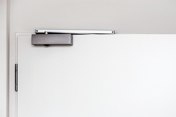 Door Closer, Modern Automatic Overhead Door Closer on White Doors. Hydraulic Magnatic Door Lock...