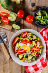 Mixed salad with cucumber, tomato, corn, egg, and tuna. Ideal for healthy eating and light meal options