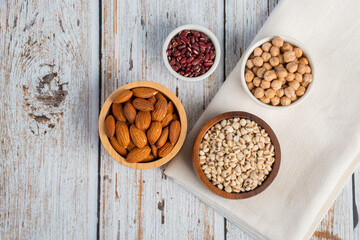 Mung beans, Red kidney beans, Chickpeas source and peeled barley in a basket wooden isolated on wood background