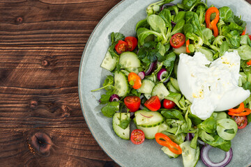 Salad of vegetables and milk Burrata cheese.