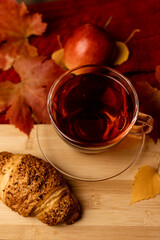 Autumn composition, tea, pumpkins, candle on the table. Autumn comfort at home
