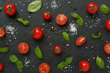 Fresh tomatoes, basil, sea salt and spices on concrete background, top view