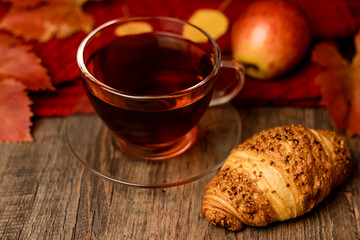 Autumn composition, tea, pumpkins, candle on the table. Autumn comfort at home