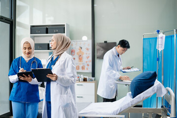 Medical professionals in modern hospital collaborating on patient care, research, and diagnosis. Doctors and nurses in hijabs discussing treatment plans, lab