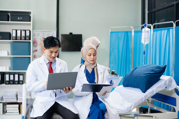 Medical professionals in modern hospital collaborating on patient care, research, and diagnosis. Doctors and nurses in hijabs discussing treatment plans, lab