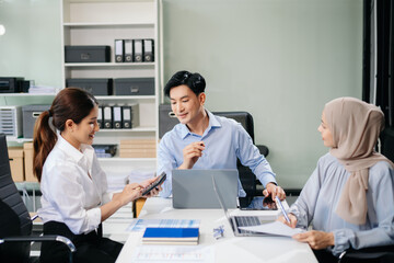 Office colleagues have a casual discussion. During a meeting in a conference room, a group of business teem