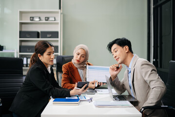 Office colleagues have a casual discussion. During a meeting in a conference room, a group of business teem