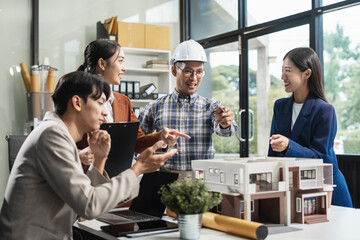 Engineer teams meeting working together wear worker helmets hardhat on construction site. Asian industry professional team.