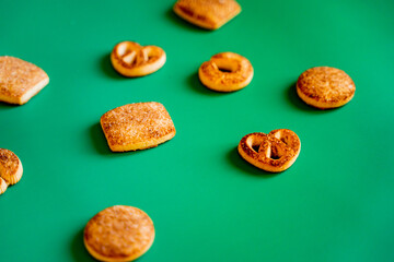 New Year's cookies with a sprinkle of cinnamon and sugar on a green New Year's background, delicious pastries for the New Year and Christmas