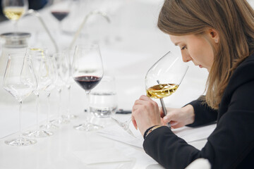 Female sommelier degustate white wine during training wine school. Blind wine tasting. Winemaking...