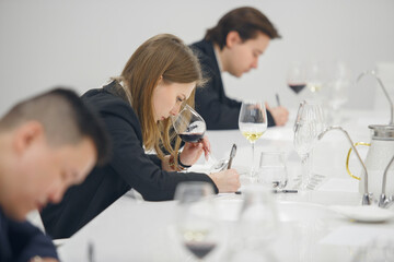 Sommelier association during wine tasting, wine school. Wine waiters degustates various alcohol beverages on training. Blind wine tasting.