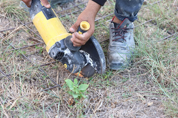 worker cutting metal with an angle grinder