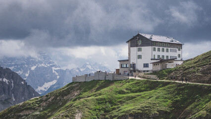 Big and beautiful alpine refugee on a cloudy winter day with the mountains in the background