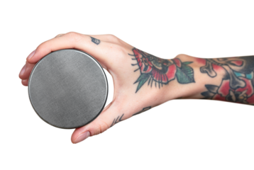 Tattooed hand holding face cream jar transparent png