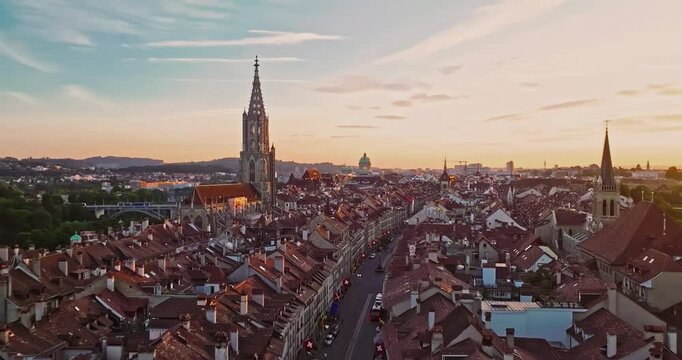 Aerial view over the city of Bern the capital city of Switzerland the historic district from above. Bern old town. The historic buildings in the city center. Wide establishing aerial golden sunset