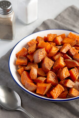 Homemade Roasted Sweet Potatoes on a Plate, side view. Close-up.