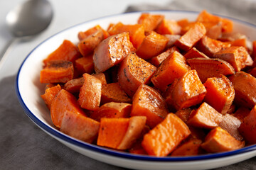Homemade Roasted Sweet Potatoes on a Plate, side view. Close-up.
