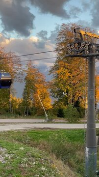 Cable car in autumn. cabins move against the background of mountains on Gazprom Polyana.
