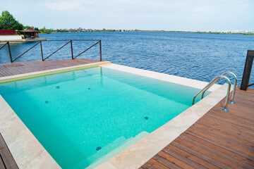 Terrace with swimming pool by the river.