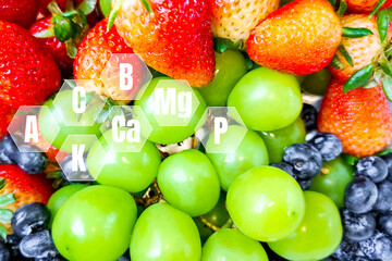 Healthy raw food concept. Green grapes, blueberries, and strawberries with a virtual screen to show vitamins in fruit.