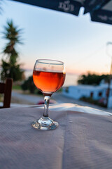 glass of red wine on table at sunset on a serene evening