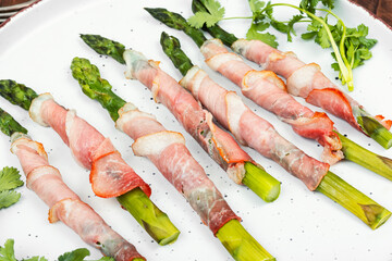 Young green asparagus in bacon.