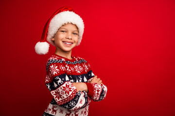 Photo portrait of cute little boy crossed hands confident celebrate new year wear knitted outfit isolated on red color background