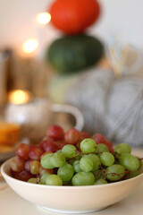 Pumpkins, various food and drinks, fall decorations, books and candles on the table. Fall hygge at home. Selective focus.