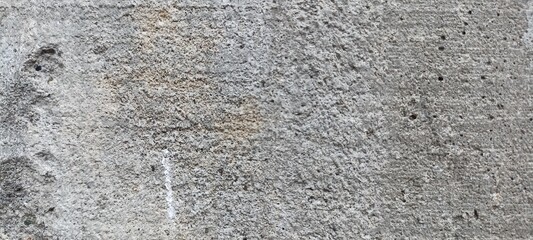 Rough Concrete Surface Texture Close-Up. A detailed close-up of a rough concrete surface, showcasing natural imperfections and a rugged texture, for industrial designs or as a grunge background