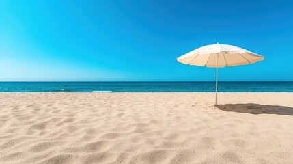 Fototapeta premium Serene Beach Scene with Umbrella and Blue Sky