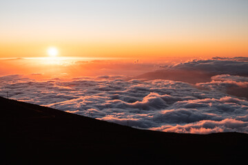 Sunset at Haleakala lookout with spectacular cloud formations as seen from the highest point on Maui in the evening (Hawaii, USA)