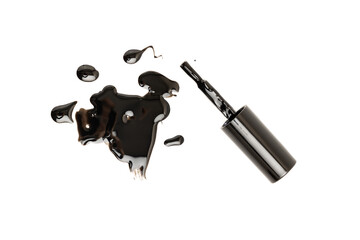 Nail polish brush and a puddle of spilled polish on a table