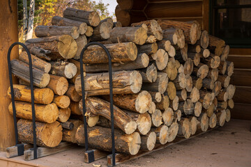 Stacked firewood next to a cabin in the colorado mountains