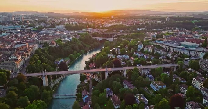 Aerial view over the city of Bern the capital city of Switzerland the historic district from above. Bern old town. The historic buildings in the city center. Wide establishing aerial golden sunset