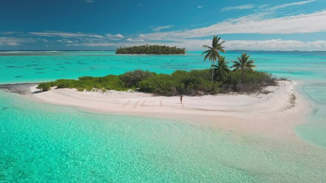 Woman walks alone on a desert island with turquoise sea and palm trees swaying, a message help in the sand adds mystery to this tranquil paradise