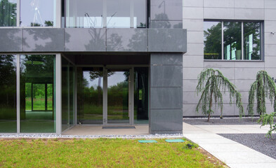 Modern glass office building and lawn