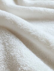 Close-up of soft, white fabric with gentle folds and cozy texture.