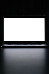 Fototapeta premium Modern laptop with blank white screen isolated on black background. Close up.
