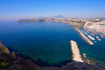 view of Procida island colorful town with small harbour from above, Italy, web banner format