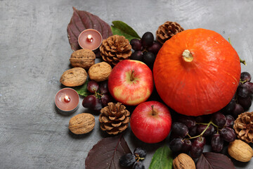 Autumn composition with fruit and leaves on grey background, top view. Healthy eating concept. 