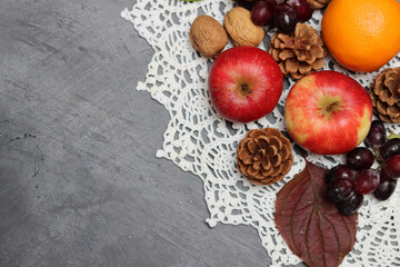 Red apples and autumn leaves on gray background. Top view, copy space