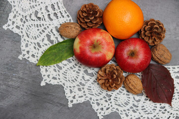 Autumn composition with fruit and leaves on grey background, top view. Healthy eating concept. 
