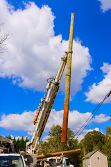 As result of severe hurricane, damaged electric pole power lines are being replaced