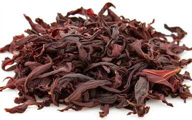 Obraz premium Dried hibiscus petals arranged in a mound on a white background, showcasing their vibrant color and unique texture