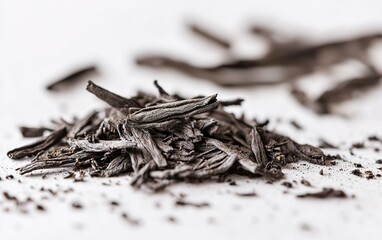 A close-up of dried herbs scattered on a light surface showcasing their texture and color in natural light